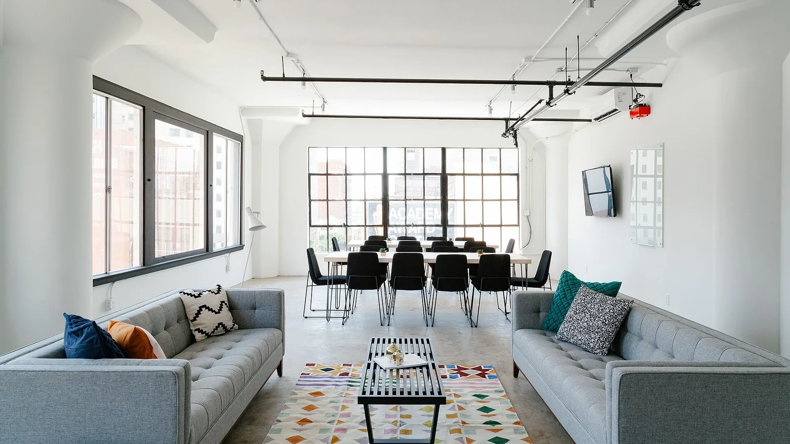 Bright modern office with a lounge area and a long meeting table