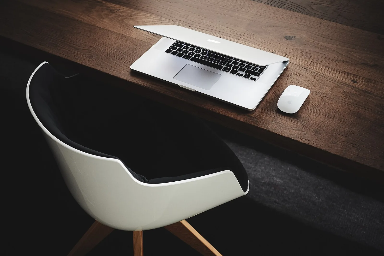 A desk with a laptop and notebook used for working through property costs