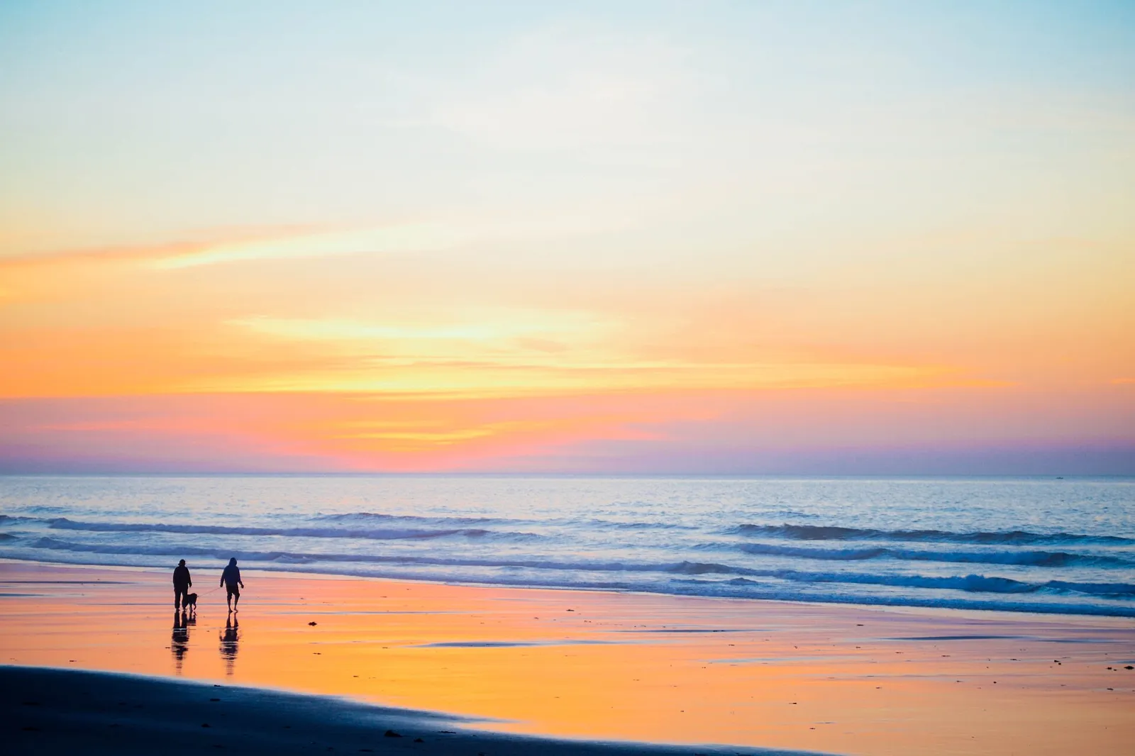Family watching the sunset together on a beach