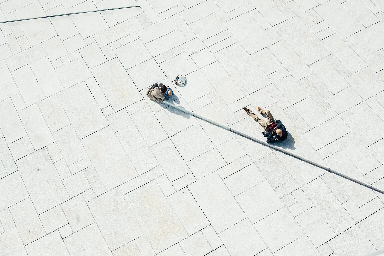 A family walking together across a sunlit European town square