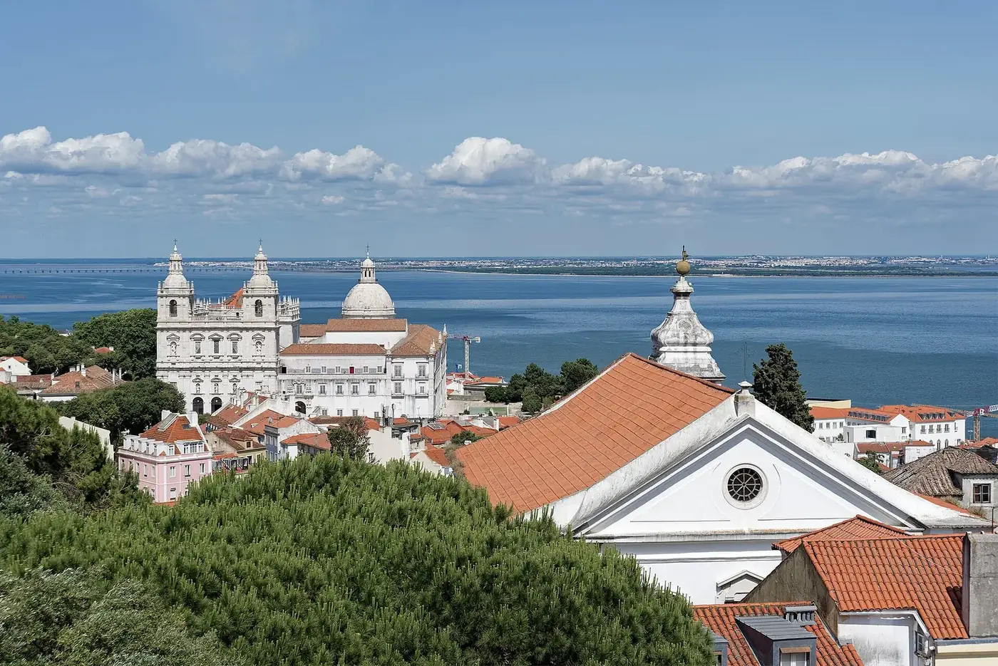 Rooftops of Lisbon's Alfama district with the National Pantheon and the River Tagus